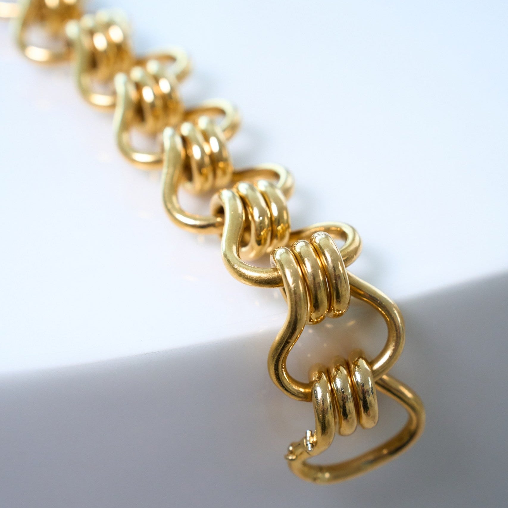 Gold bracelet on a white background