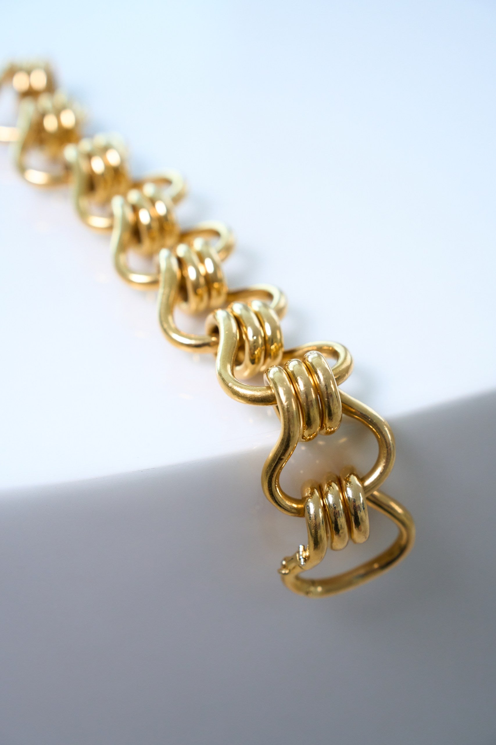 Gold bracelet on a white background